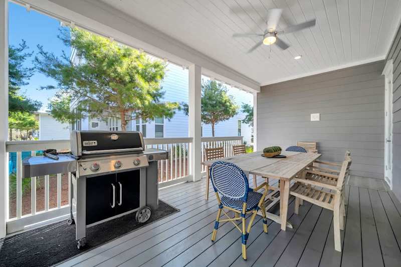 Covered private porch features a gas grill and outdoor seating