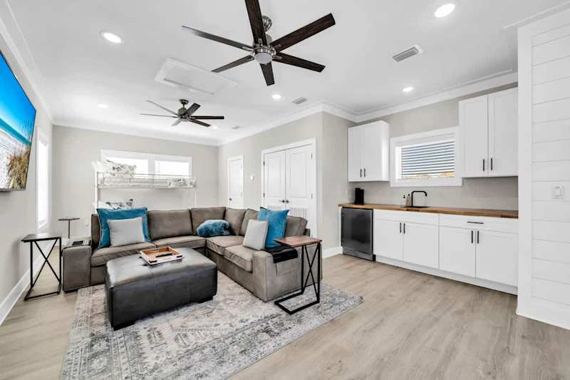 Third floor living space with bunk, private porch access, smart tv, and kitchenette.