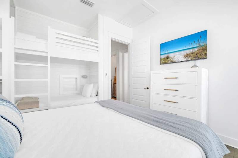 Guest bedroom features smart tv and access to private porch