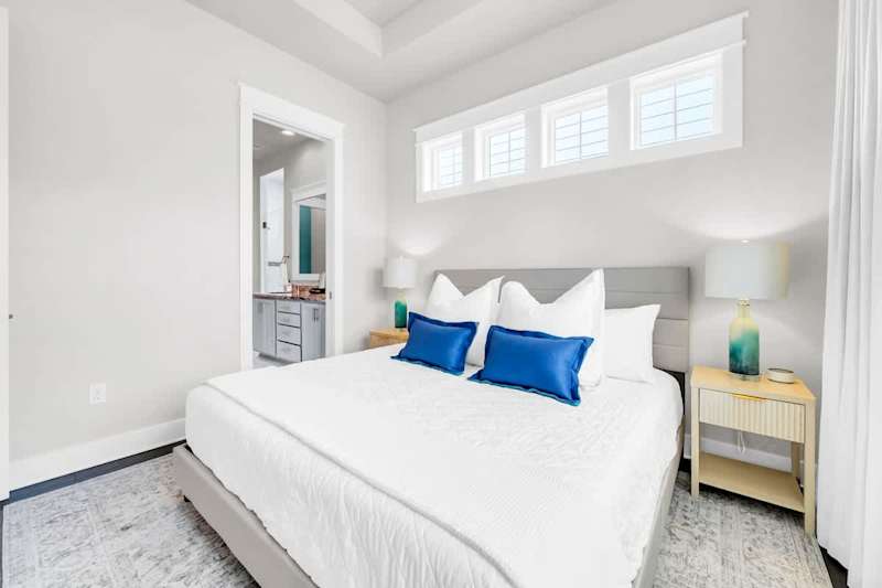 King bed in primary bedroom with a ensuite, walk-in closet, and smart tv