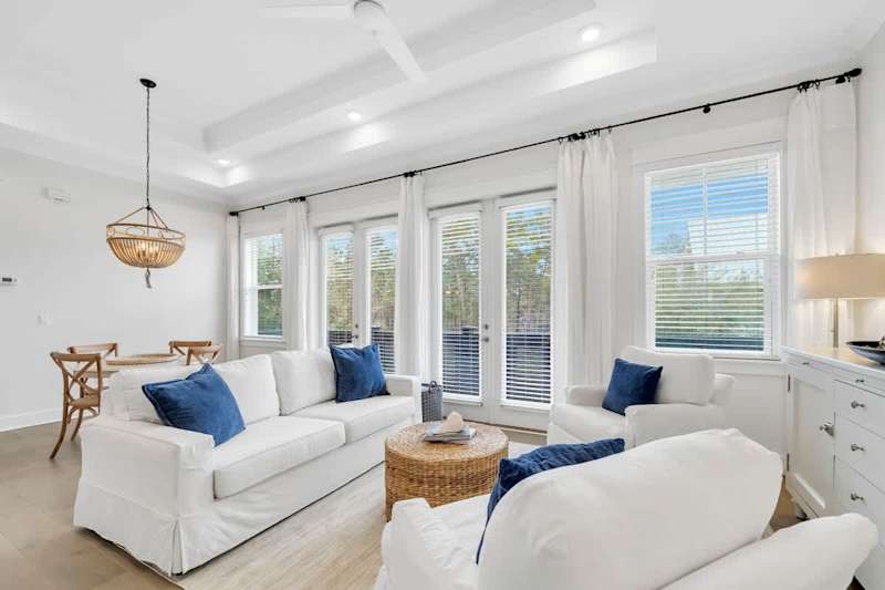 Living room includes plenty of seating with a smart tv.