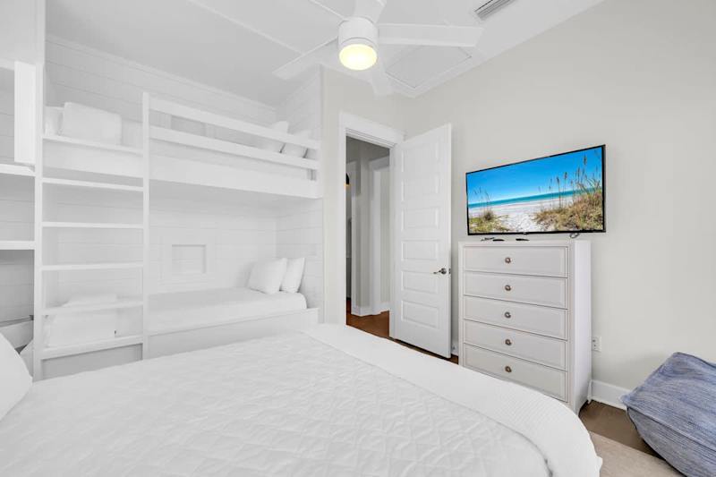 Guest bedroom features a queen bed + twin/twin bunk with smart tv.