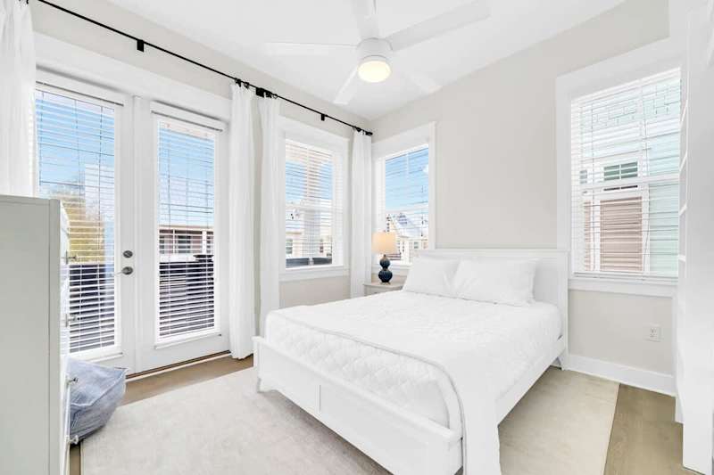 Guest bedroom features access to private balcony