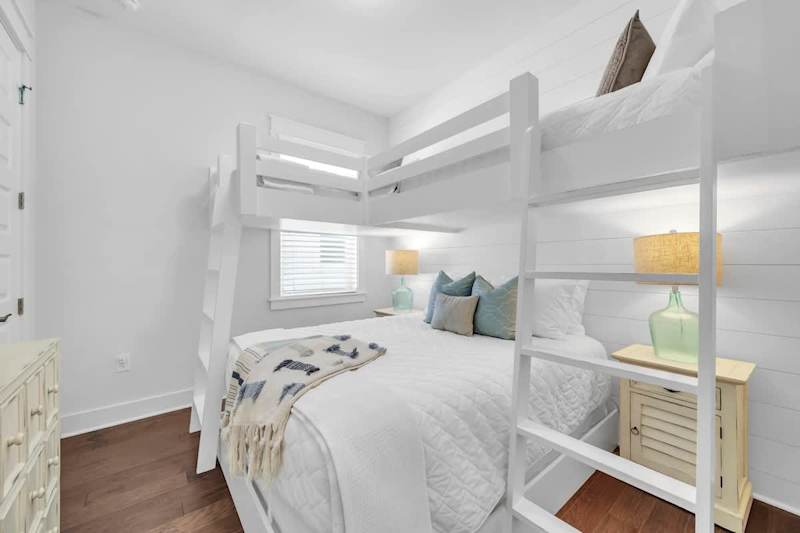Bedroom #2 features two twin beds over A Queen bed with smart tv.