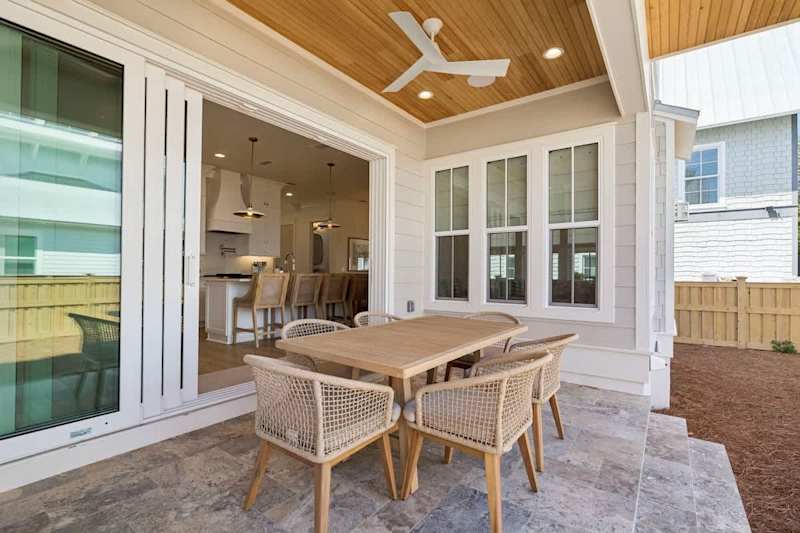 Private outdoor covered patio in backyard with table for 6