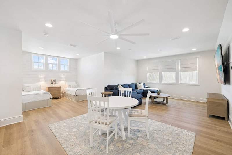 Third floor loft features  living/dining space with 100 inch tv + additional (2) twin beds