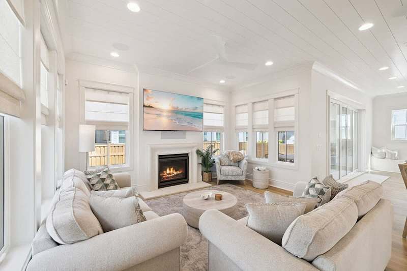 Living room features seating for all, smart tv and fireplace