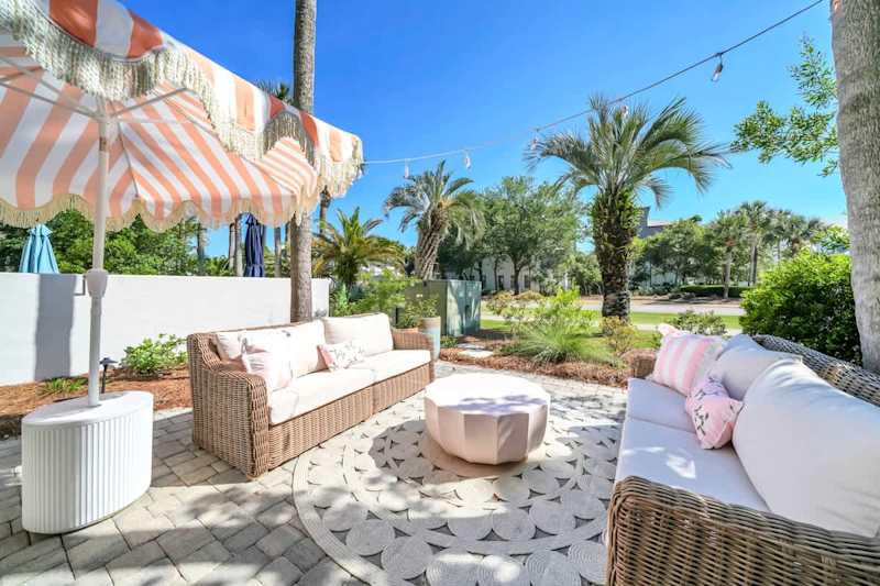 Enjoy the private back patio with seating + step right out onto 30A!