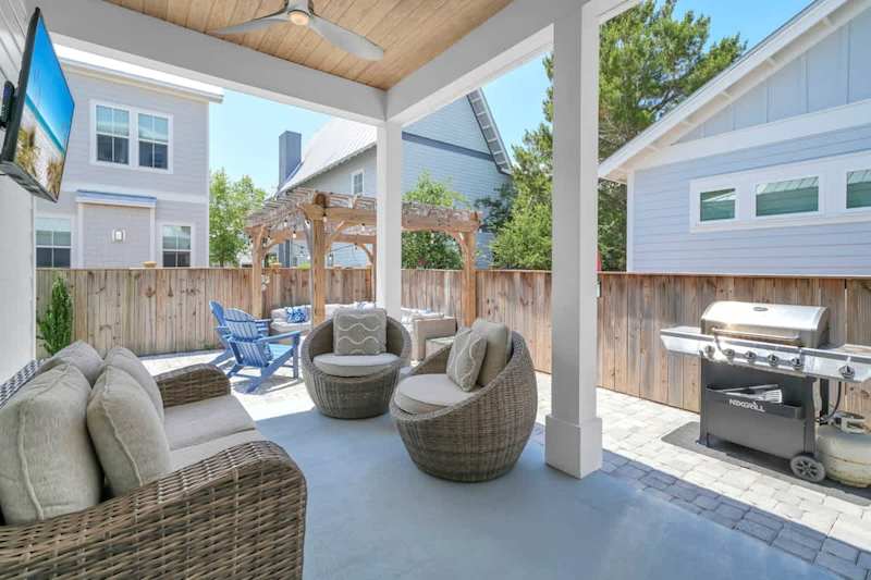 Backyard features seating, gas grill, firepit, and tv