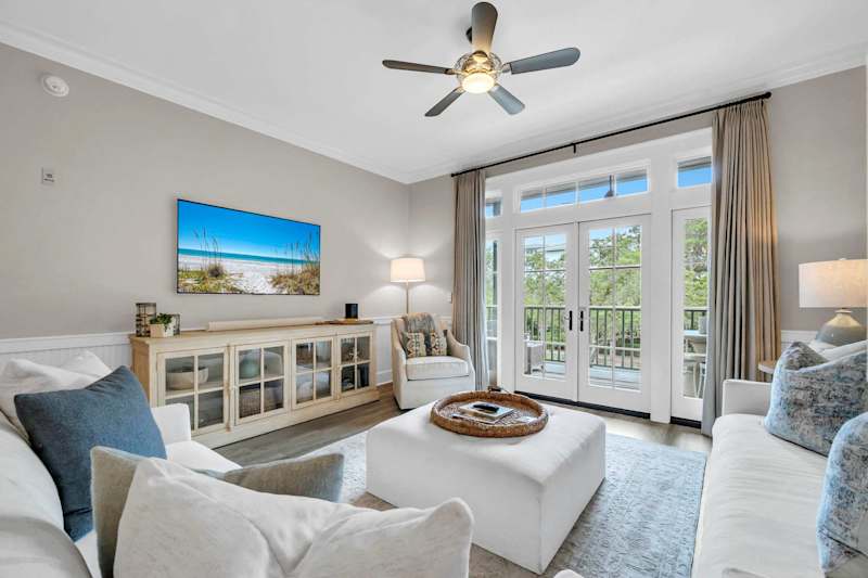 Living room features seating for all, smart tv, and porch access
