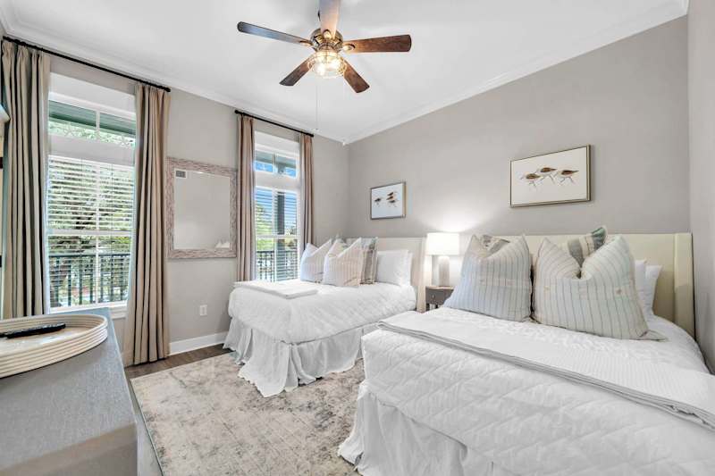 Guest bedroom features (2) double beds, smart tv, ensuite bathroom, and porch access