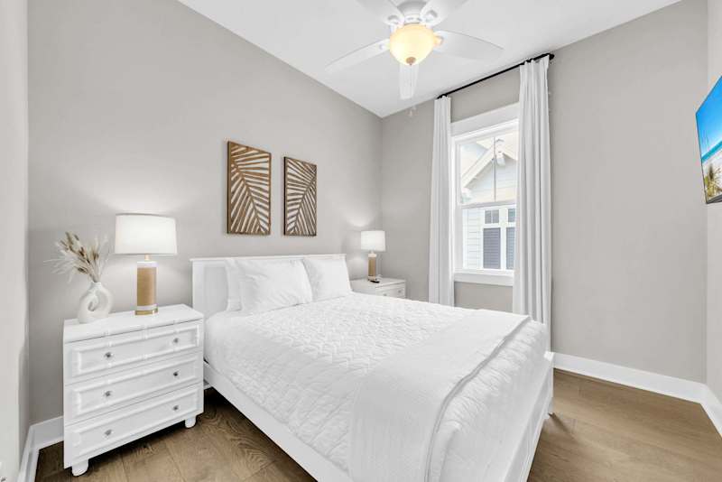 Guest bedroom features a queen with smart tv