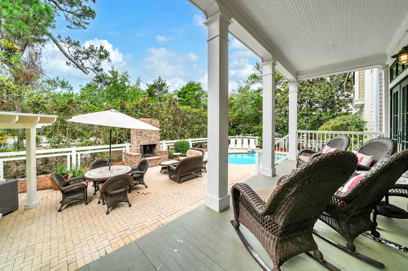 Private backyard oasis with pool, seating, fireplace, & grill