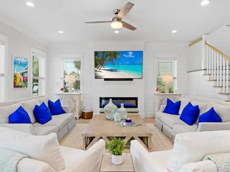 Living room includes plenty of seating for all, including rocking swivel chairs for lounging.