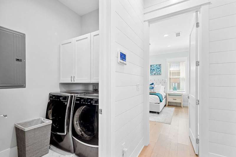First floor laundry room features a large capacity washer and dryer.