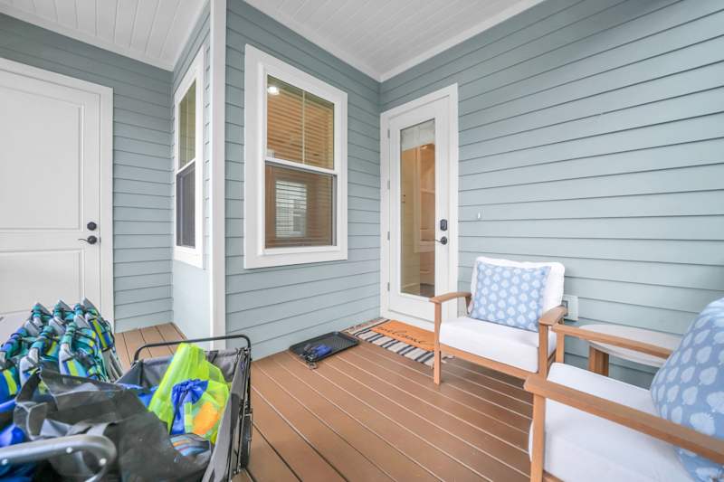 Covered screened in porch in back with seating