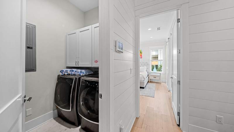 First floor laundry room features a large capacity washer and dryer.