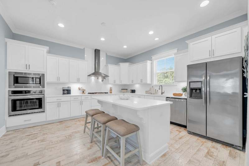 Fully stocked kitchen with additional island seating for 3