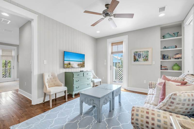 Second floor living room with smart tv, seating, and access to second floor balcony