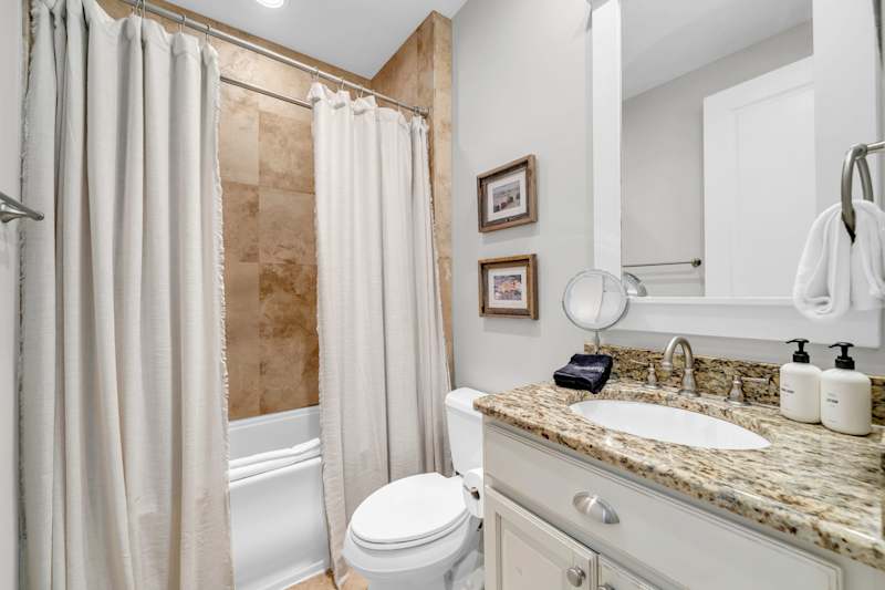 Second floor hall shower featuring shower/tub combo