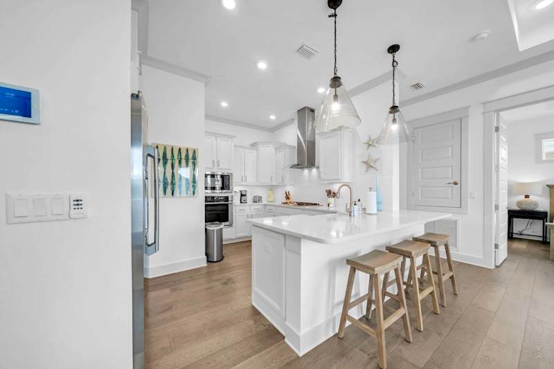 Kitchen feature an island with seating for 3