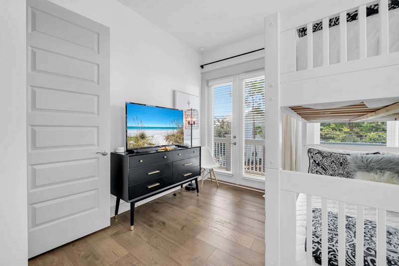 Guest bedroom features a smart tv & access to balcony