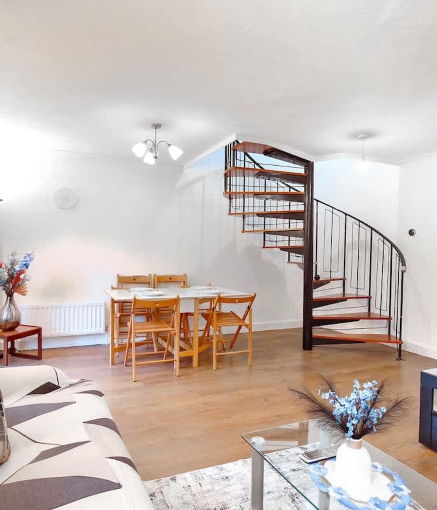 The living room and stairs in our house in Merton