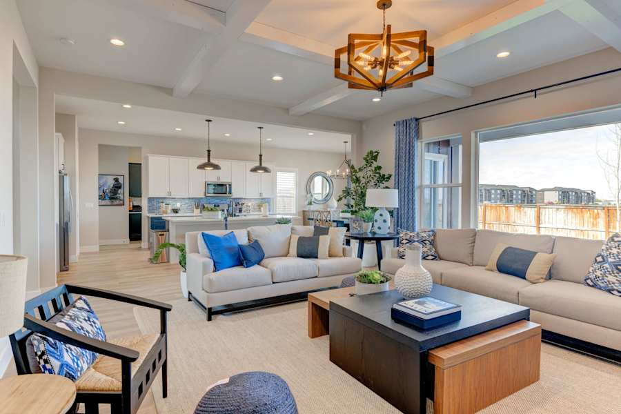 The living room has a cozy fireplace, a mounted TV and plush seating.