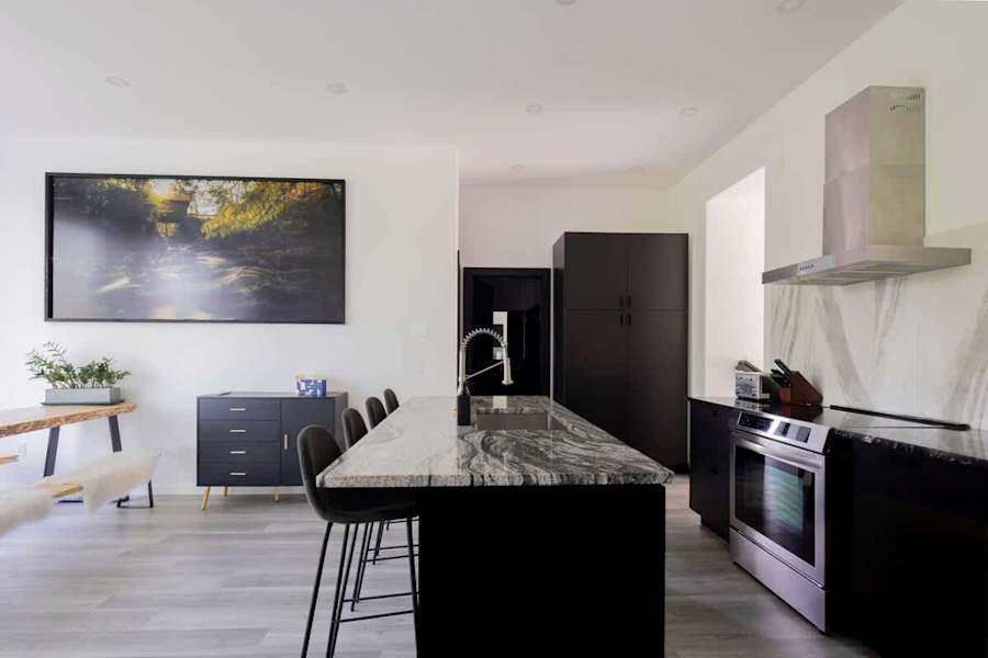 The kitchen, with an island counter and stools.