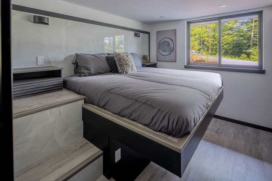 The bedroom, with a raised king bed.