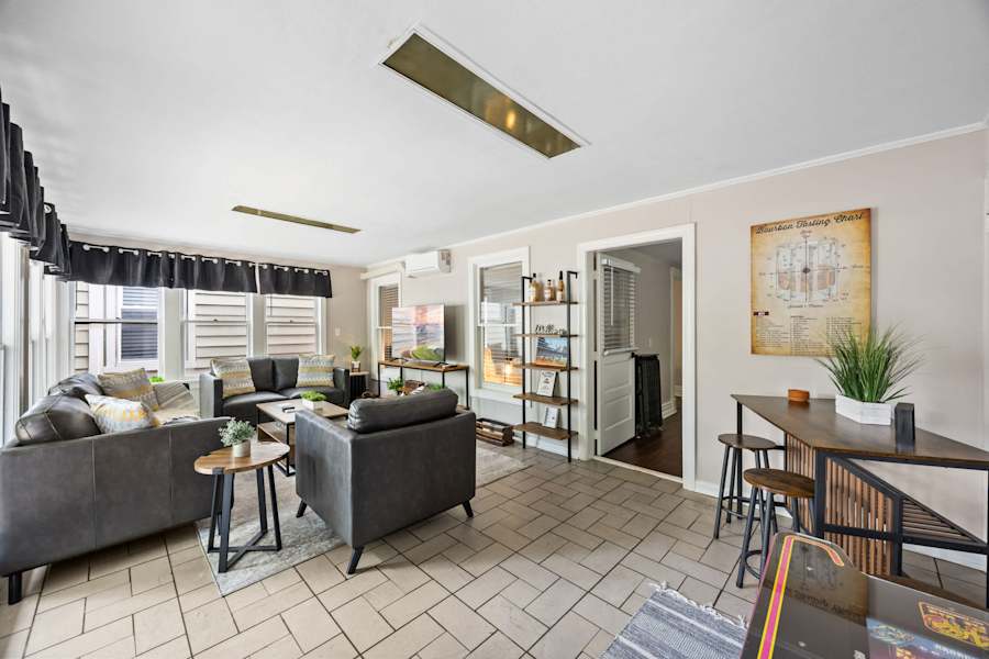 The living room in the first-floor apartment has comfortable seating and a Smart TV.