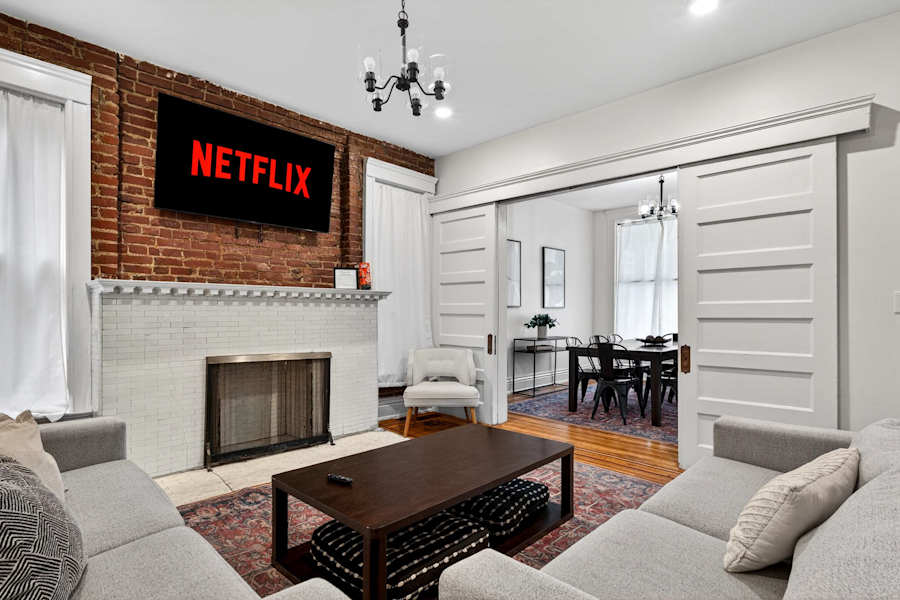 The living room, with a sectional sofa and a smart TV.