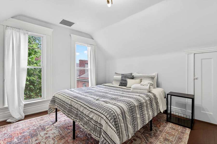 Bedroom 5, with a king bed, dresser and closet.
