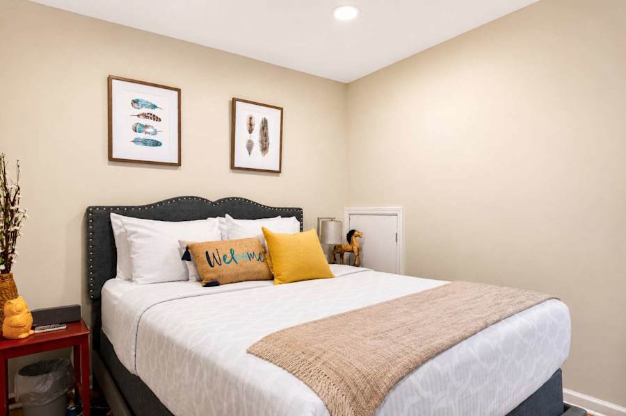 The bedroom has a plush queen bed and soft linens.