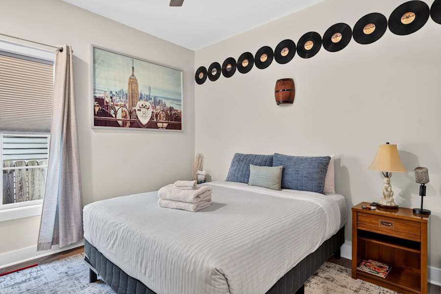The ground-floor bedroom has a queen bed and plush bedding.