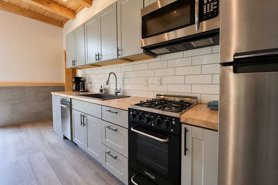The kitchen, with stainless steel appliances and a coffee maker.