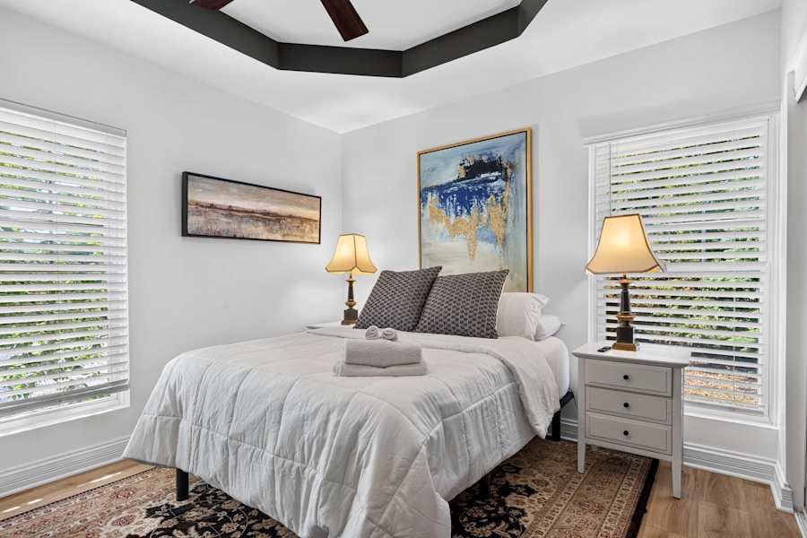 A bedroom with comfortable bedding and soft natural light.