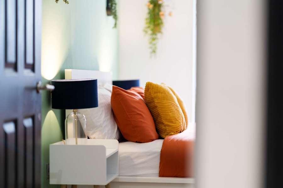 The living room of the Stylish 1-Bedroom with Garden apartment in Clapham, with a sofa, dining table and doors to a private garden